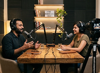 Video production company in Chennai recording podcast with professional studio setup and microphones 